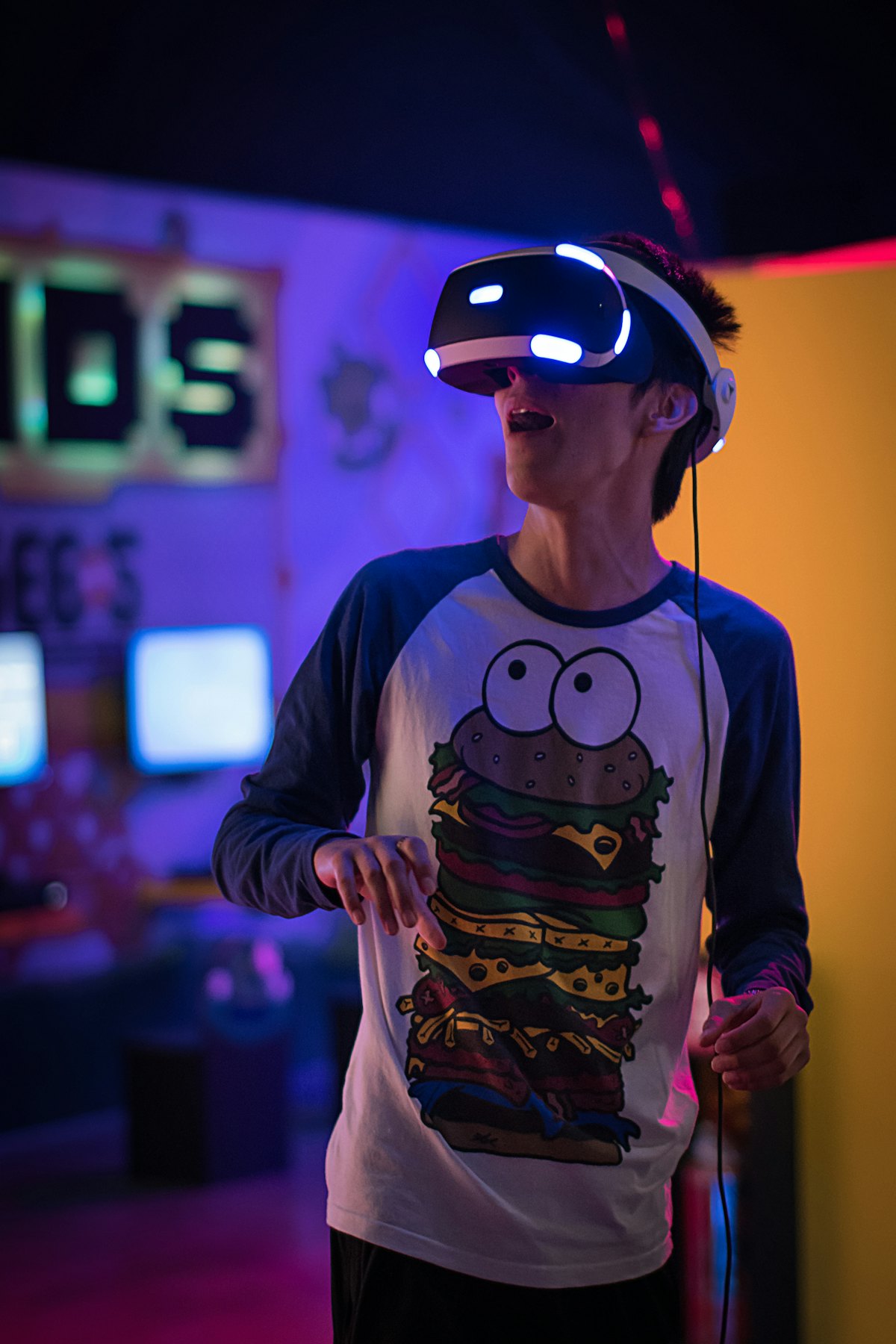 A young person wearing a VR headset in a colourful room