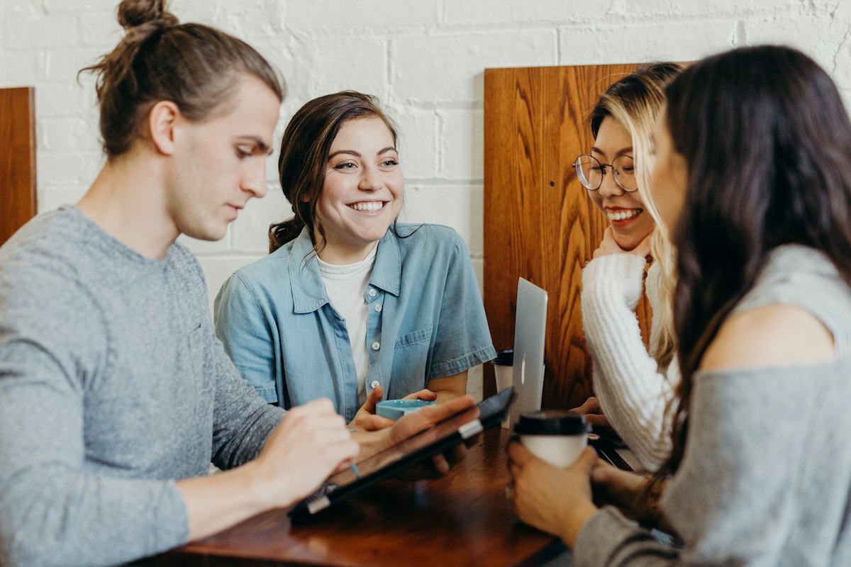 Friends laughing together around a table