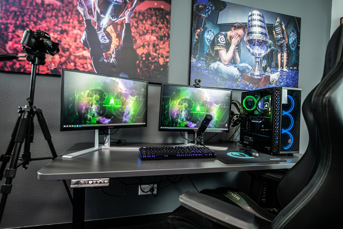 A streaming desk with monitors, a camera and lights
